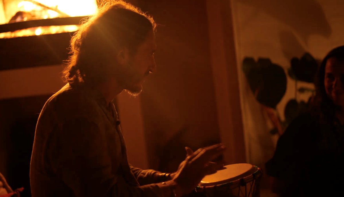 Skai drumming by the fire